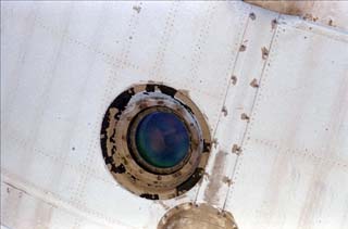 Mir-24 flight engineer Pavel Vinogradov is photographed looking out of the Base Block window. 